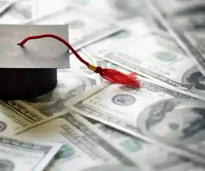 A graduation cap sitting on money.